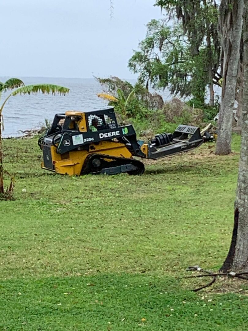 A yellow and black vehicle is parked in the grass.